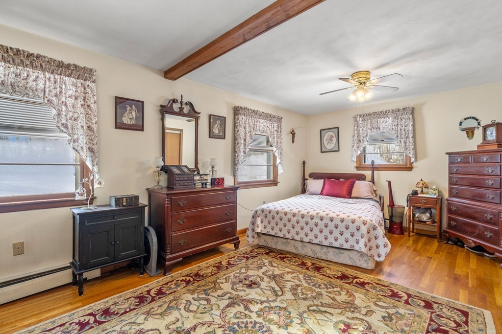 82 Glenwood Road Rutland, MA 01543 - Photo 15 of 30 a bedroom with a bed and wooden floor