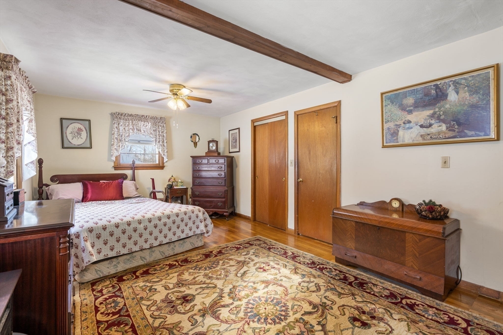 82 Glenwood Road Rutland, MA 01543 - Photo 16 of 30 a bedroom with a bed and a chandelier