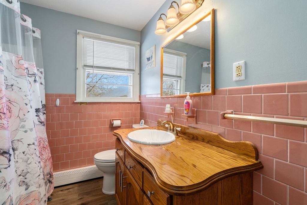 82 Glenwood Road Rutland, MA 01543 - Photo 18 of 30 a bathroom with a sink a toilet and a mirror