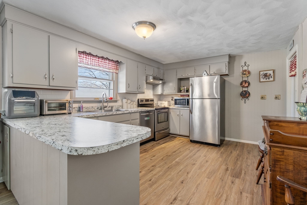 82 Glenwood Road Rutland, MA 01543 - Photo 9 of 30 a kitchen with stainless steel appliances granite countertop a refrigerator a sink a stove a microwave and island