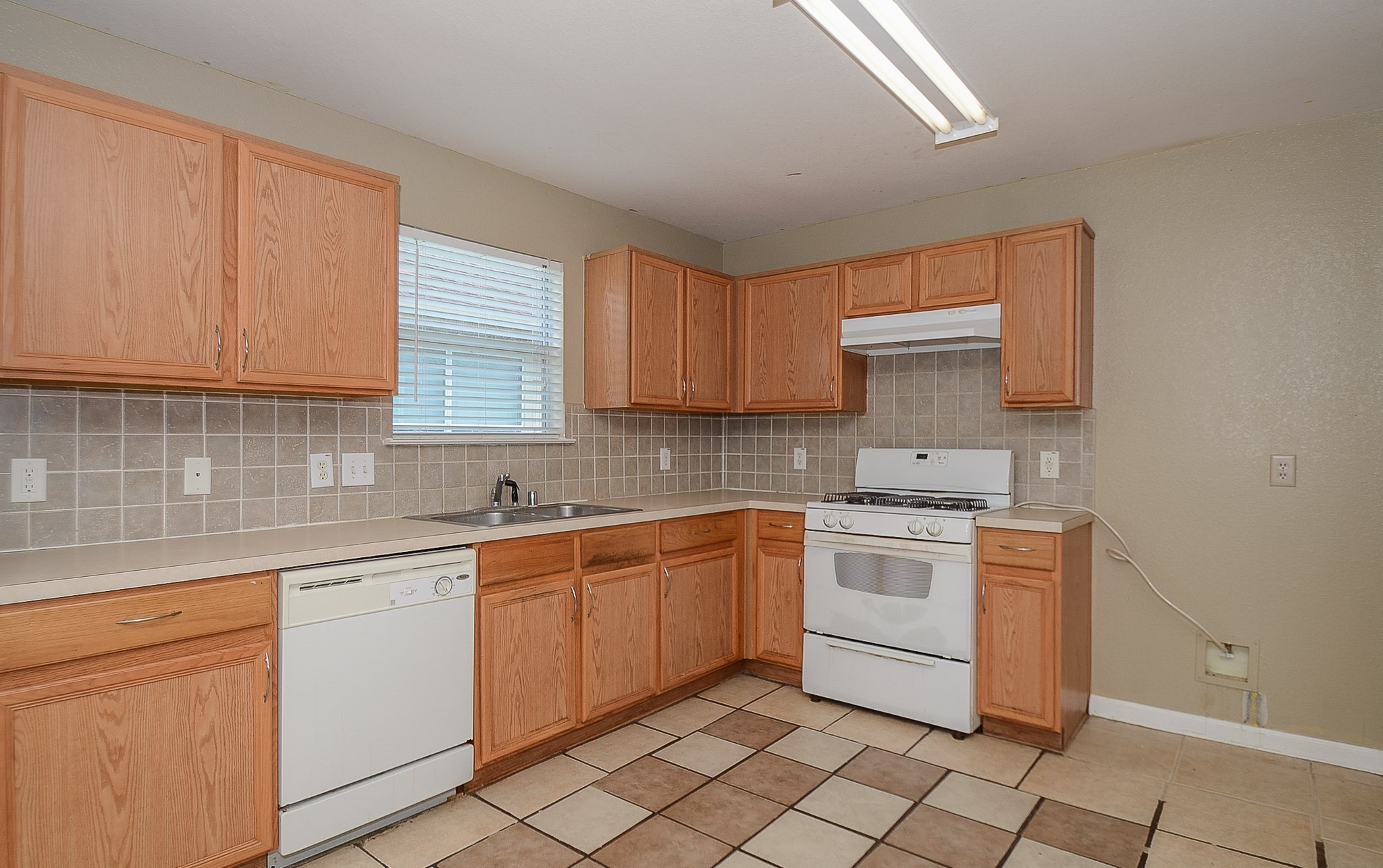 11711 Wainscot Court Houston, TX 77038 - Photo 11 of 32 a kitchen with a stove sink and cabinets