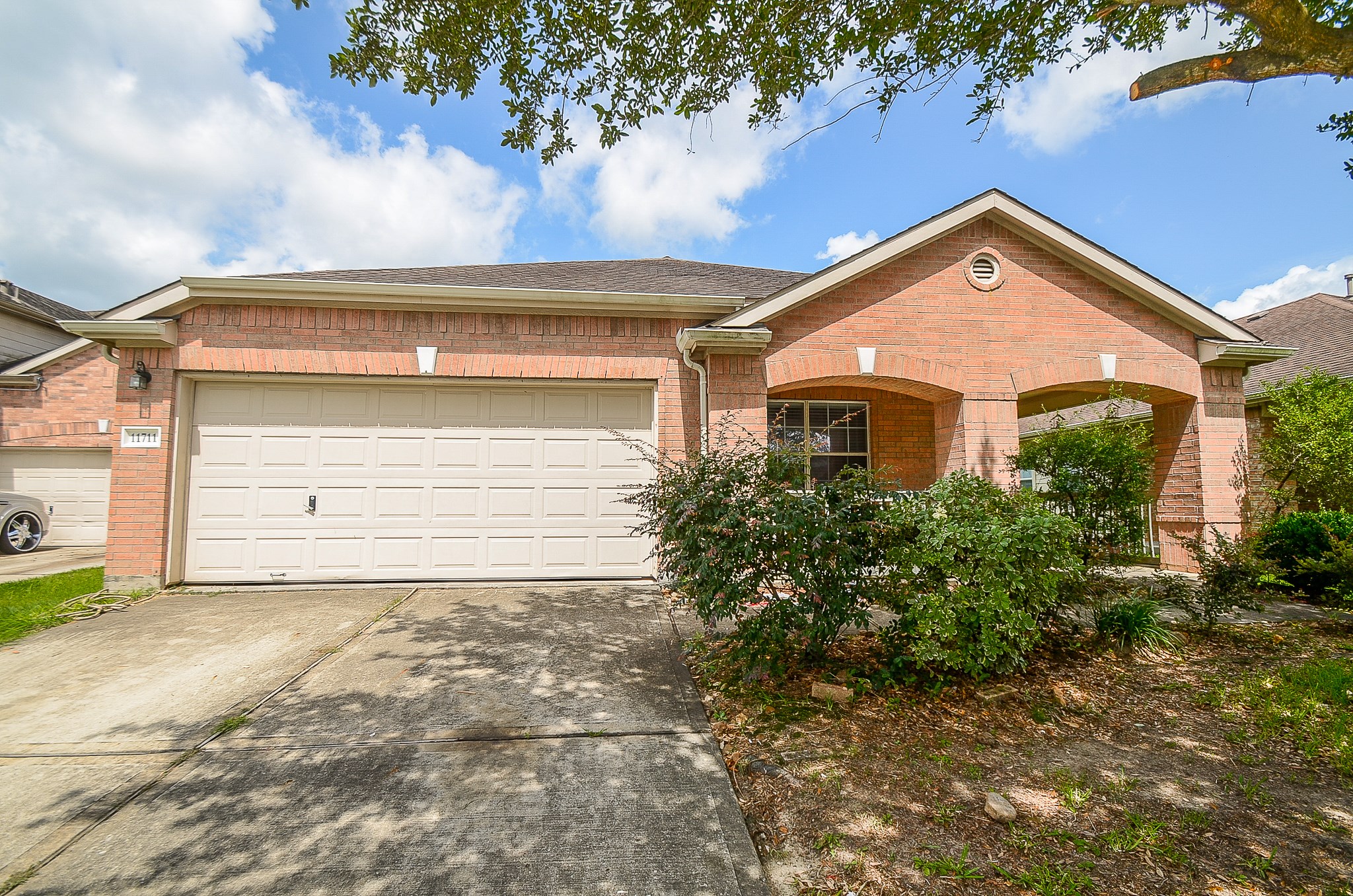 11711 Wainscot Court Houston, TX 77038 - Photo 2 of 32 a front view of a house with a yard and garage