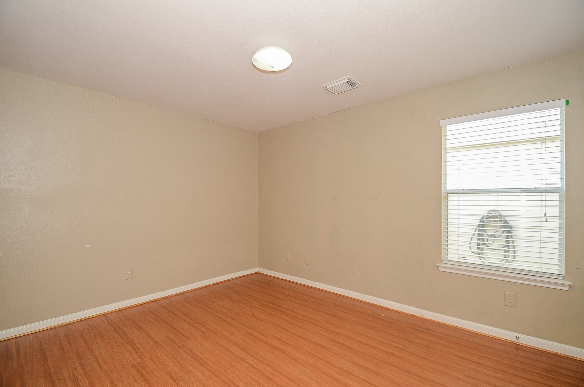 11711 Wainscot Court Houston, TX 77038 - Photo 23 of 32 wooden floor in an empty room with a window