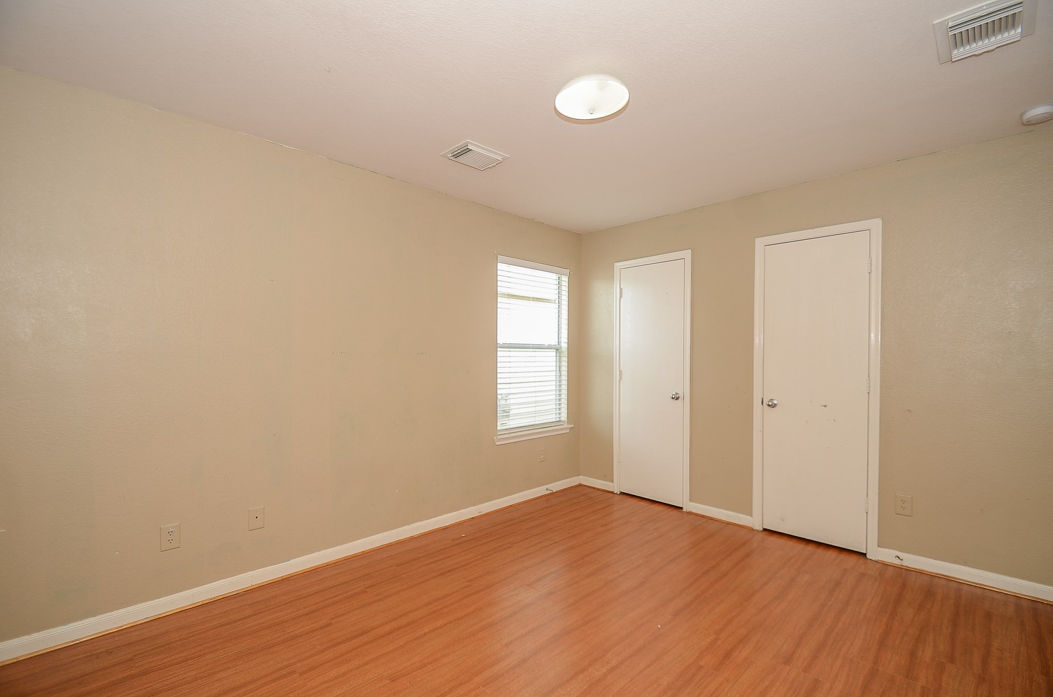 11711 Wainscot Court Houston, TX 77038 - Photo 24 of 32 a view of empty room with wooden floor and fan