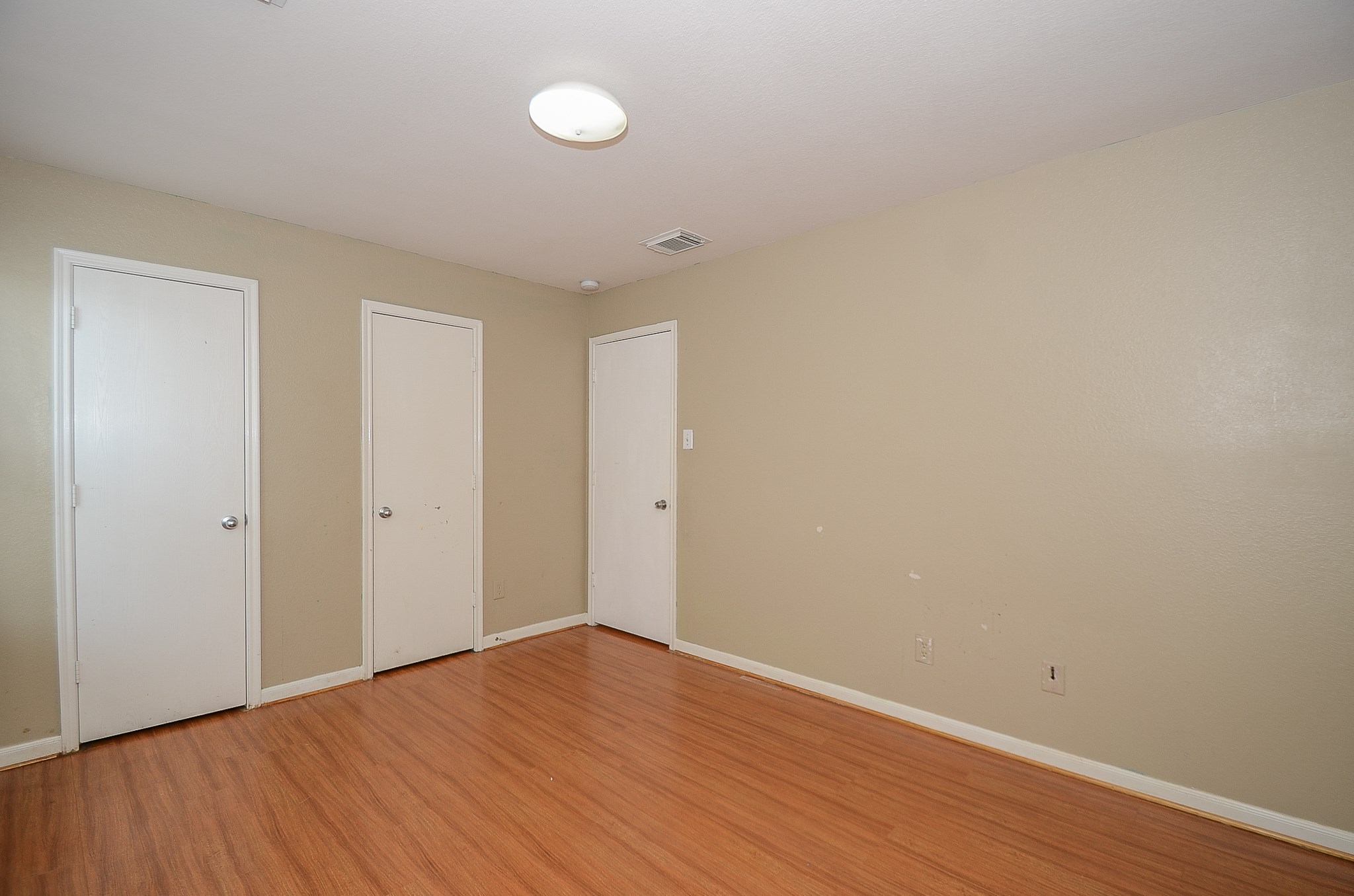 11711 Wainscot Court Houston, TX 77038 - Photo 25 of 32 a view of an empty room with wooden floor