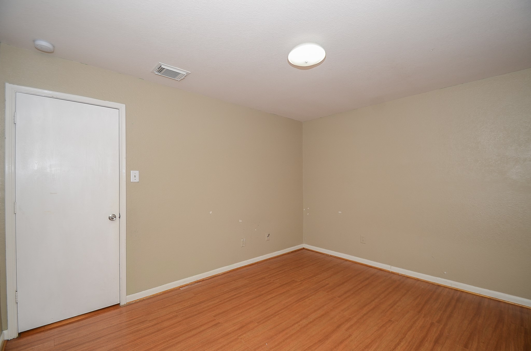11711 Wainscot Court Houston, TX 77038 - Photo 26 of 32 a view of an empty room with wooden floor