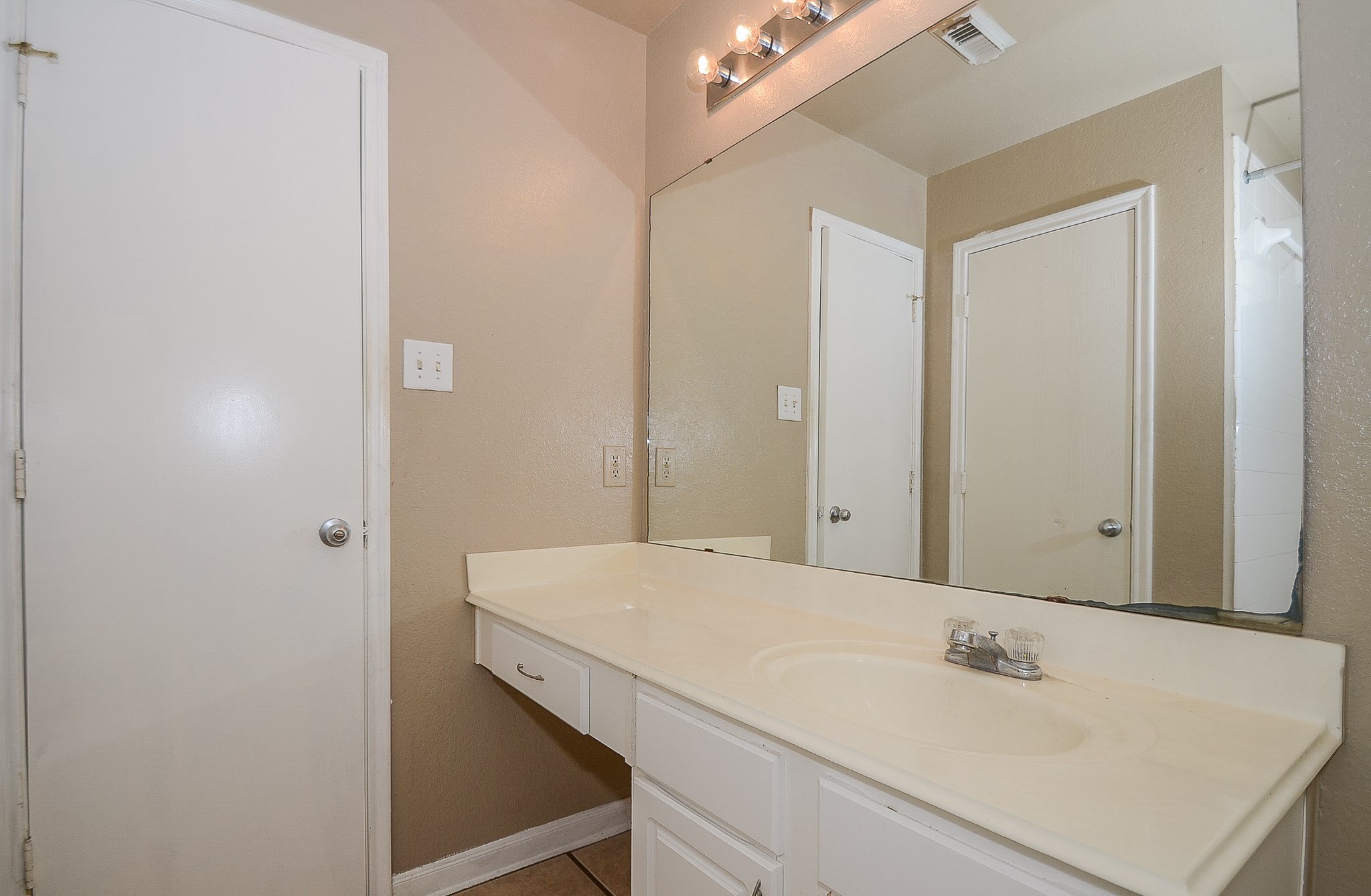11711 Wainscot Court Houston, TX 77038 - Photo 30 of 32 a bathroom with a sink and a mirror