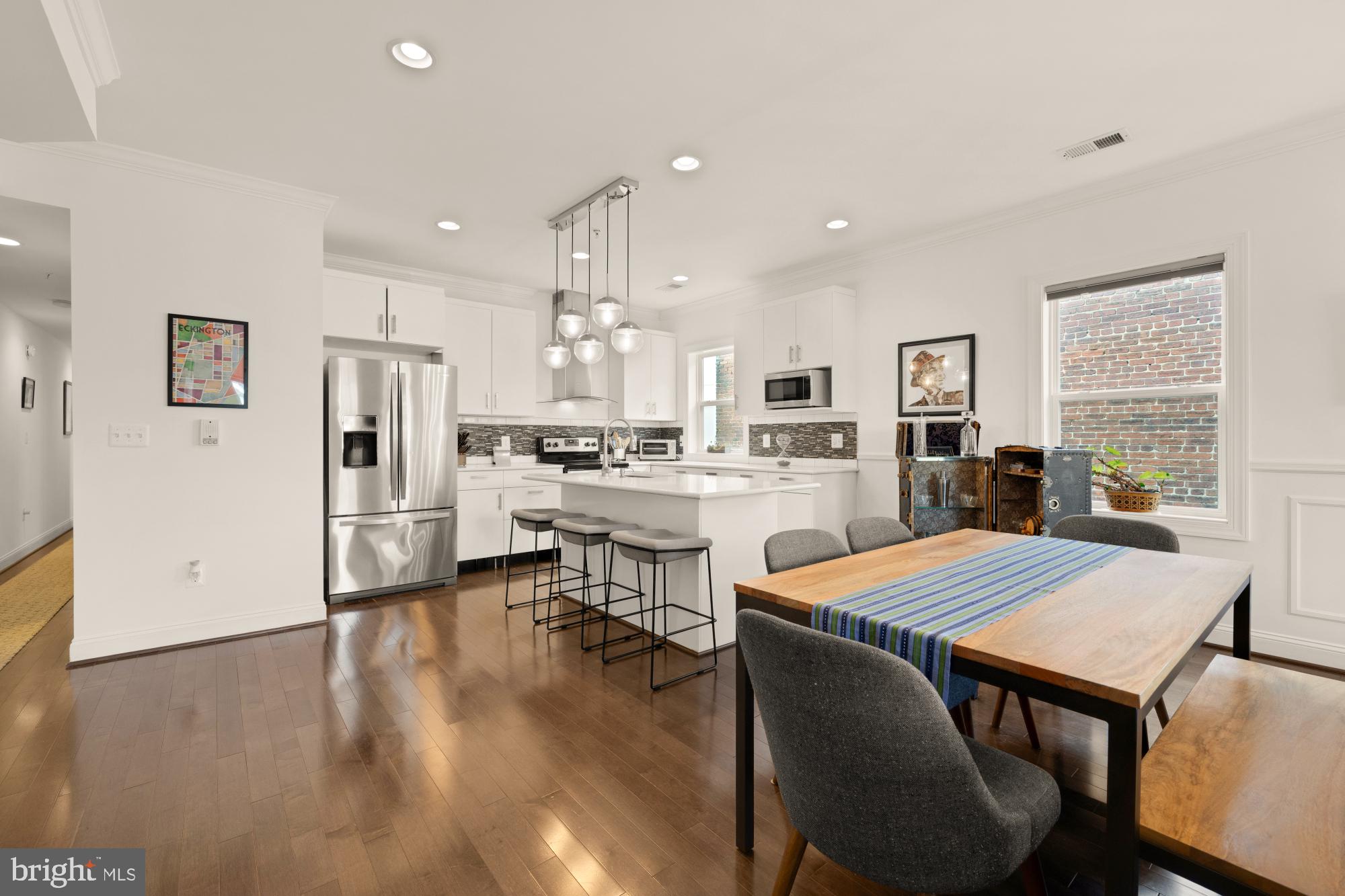 233 S Street Northeast, Unit 4 Washington, DC 20002 - Photo 11 of 37 a open kitchen with white cabinets and stainless steel appliances