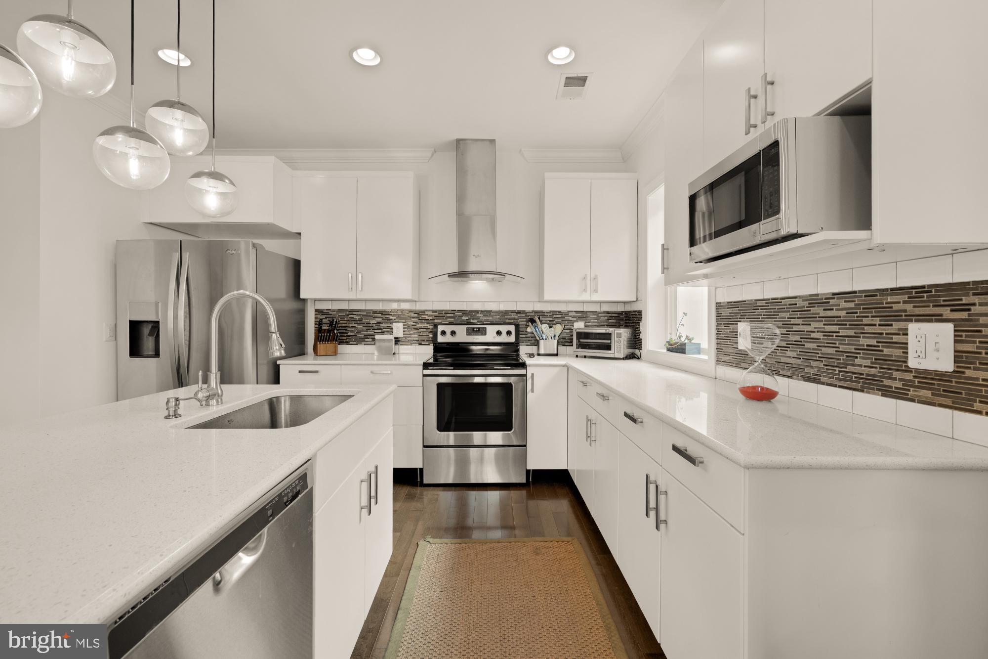 233 S Street Northeast, Unit 4 Washington, DC 20002 - Photo 14 of 37 a kitchen with a sink stove and microwave