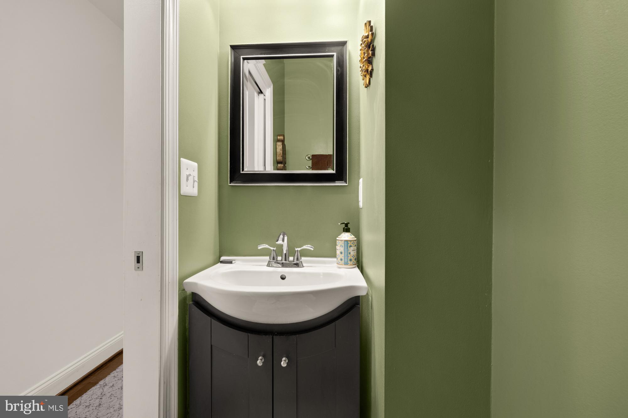 233 S Street Northeast, Unit 4 Washington, DC 20002 - Photo 17 of 37 a bathroom with a sink and a mirror