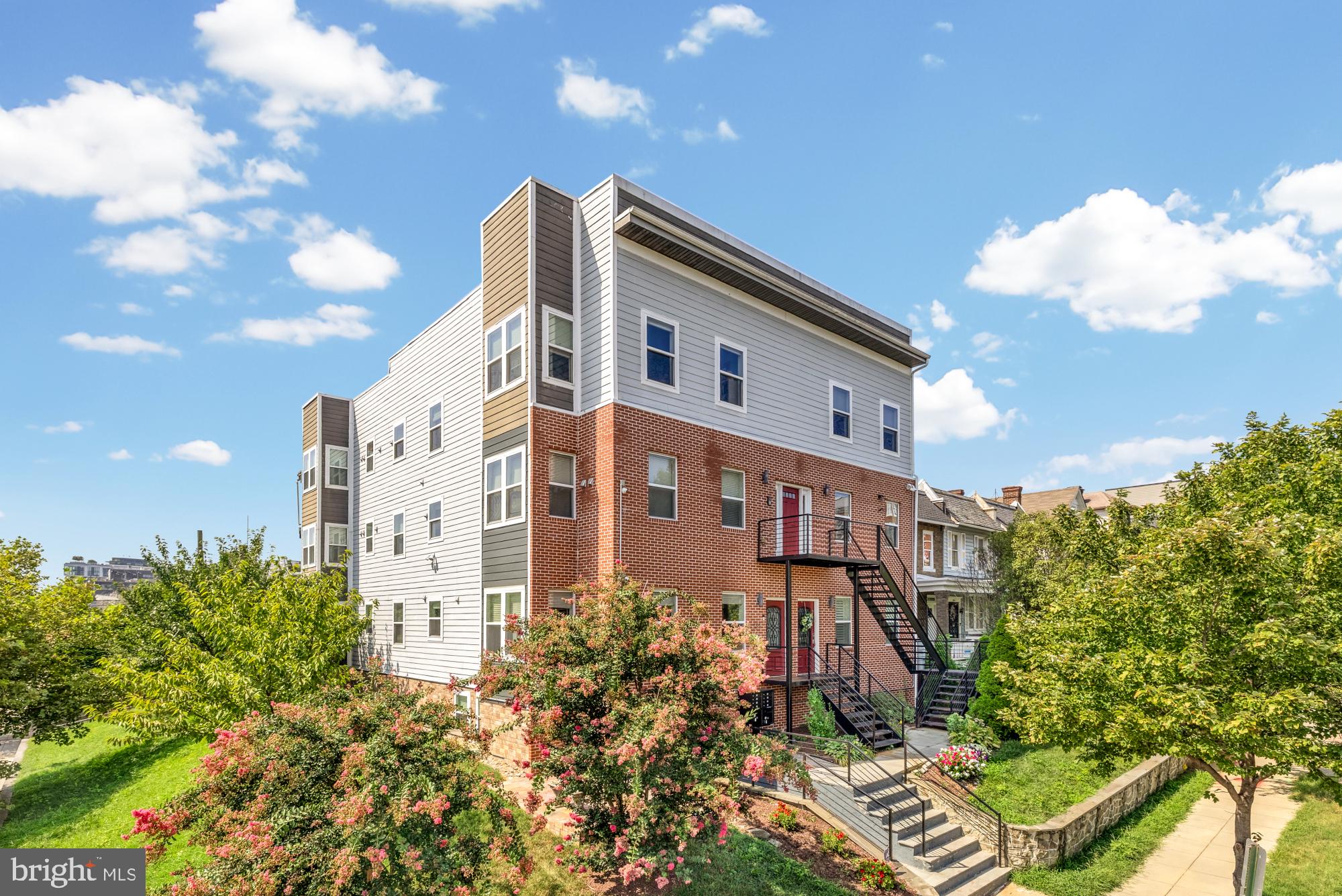 233 S Street Northeast, Unit 4 Washington, DC 20002 - Photo 2 of 37 a front view of a multi story residential apartment building with yard and parking space