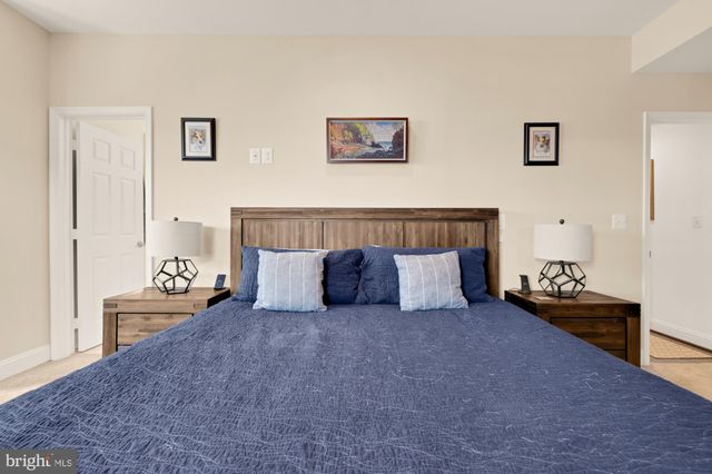 a bed room with a bed and a chair