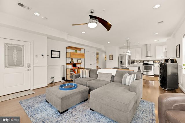 a living room with furniture and kitchen view