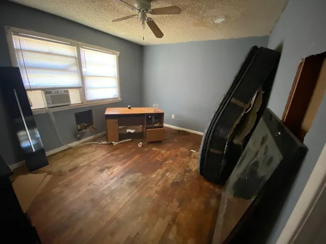 a view of a room with wooden floor and windows
