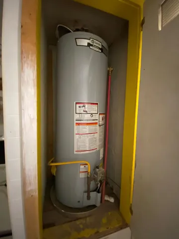 a room with water heater and utility
