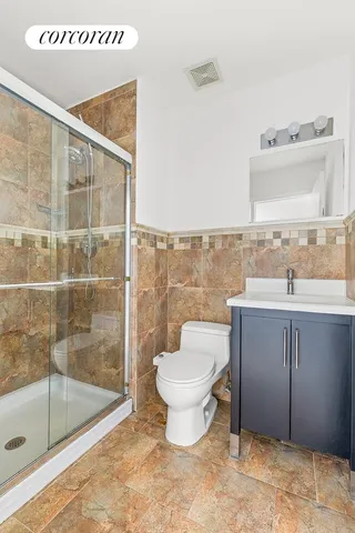 a bathroom with a toilet sink and shower