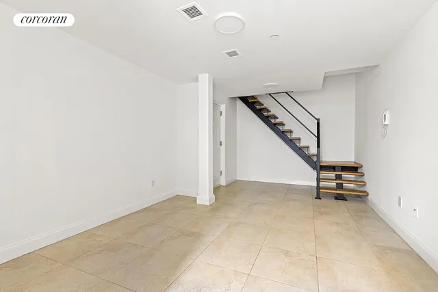 a view of an empty room with stairs