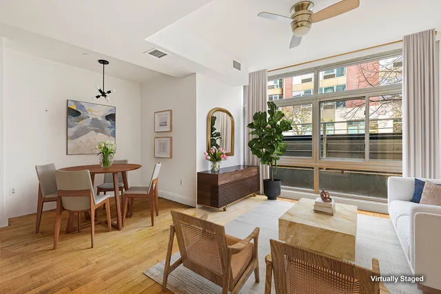 a living room with fireplace furniture and a large window