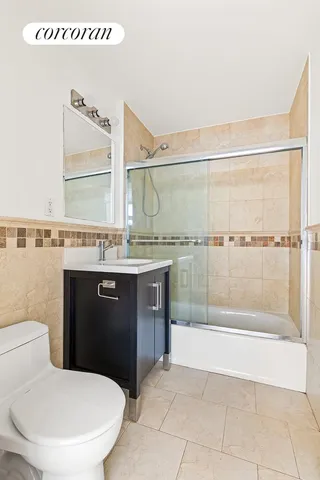 a bathroom with a granite countertop sink a mirror and a toilet