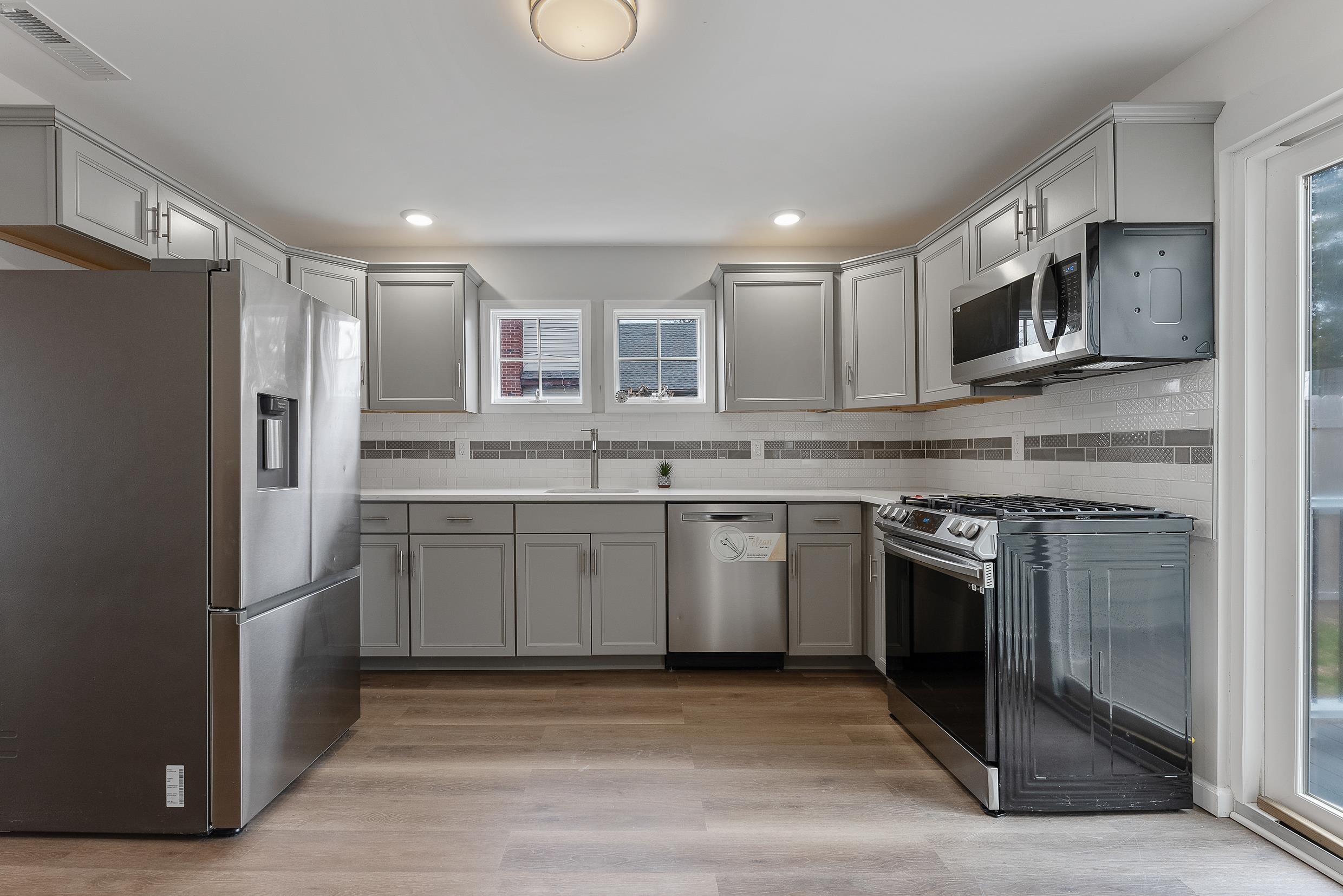 545 Seashore Road Erma, NJ 08204 - Photo 11 of 22 a kitchen with stainless steel appliances granite countertop a refrigerator stove top oven and sink