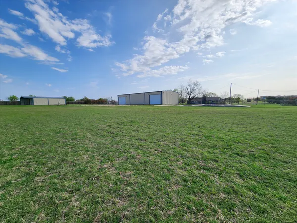 a view of a big yard with a house