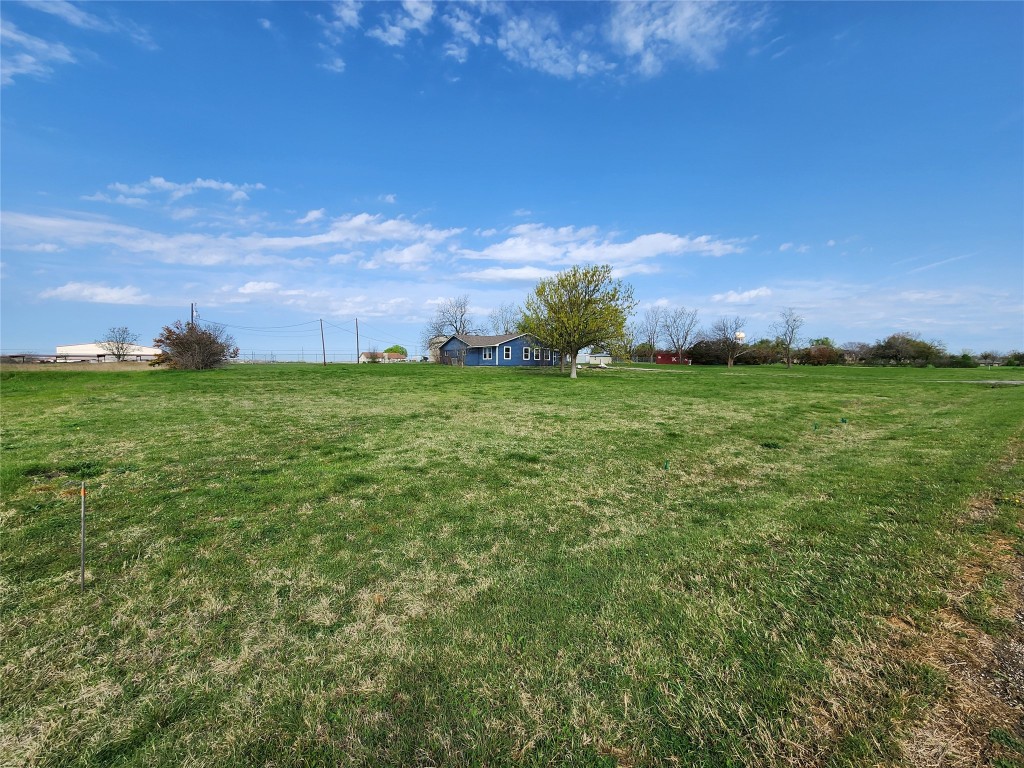 1742 Rowe Loop Pflugerville, TX 78660 - Photo 2 of 13 a view of a big yard with a house in the background