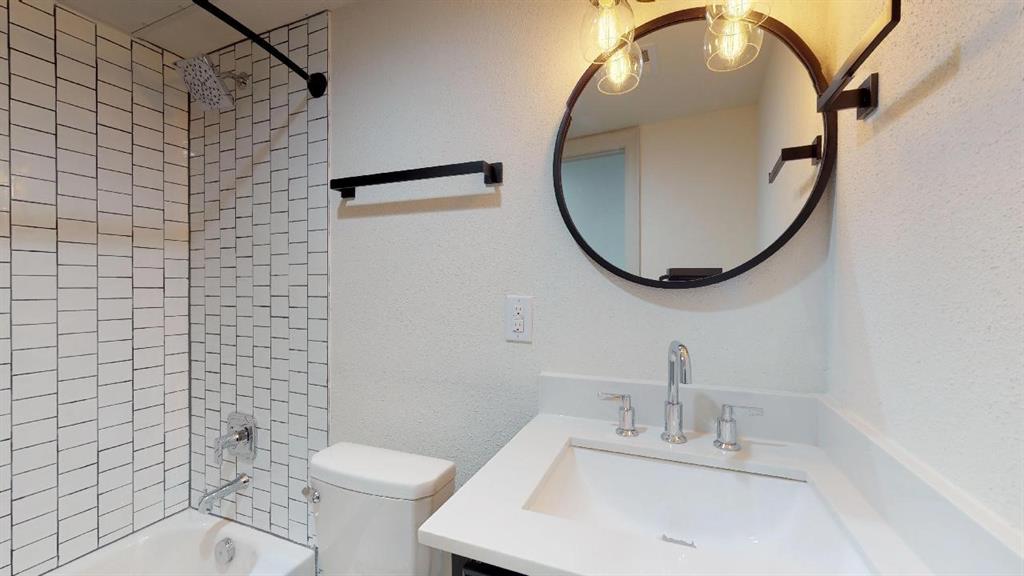5506 Miller Avenue, Unit 202 Dallas, TX 75206 - Photo 12 of 17 a bathroom with a sink a toilet and a mirror