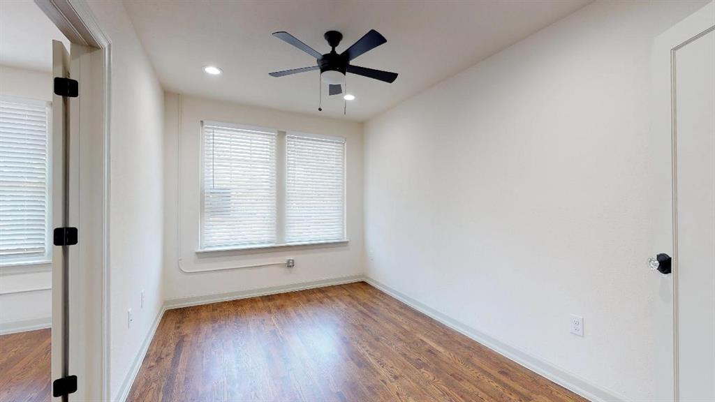 5506 Miller Avenue, Unit 202 Dallas, TX 75206 - Photo 13 of 17 an empty room with wooden floor and windows