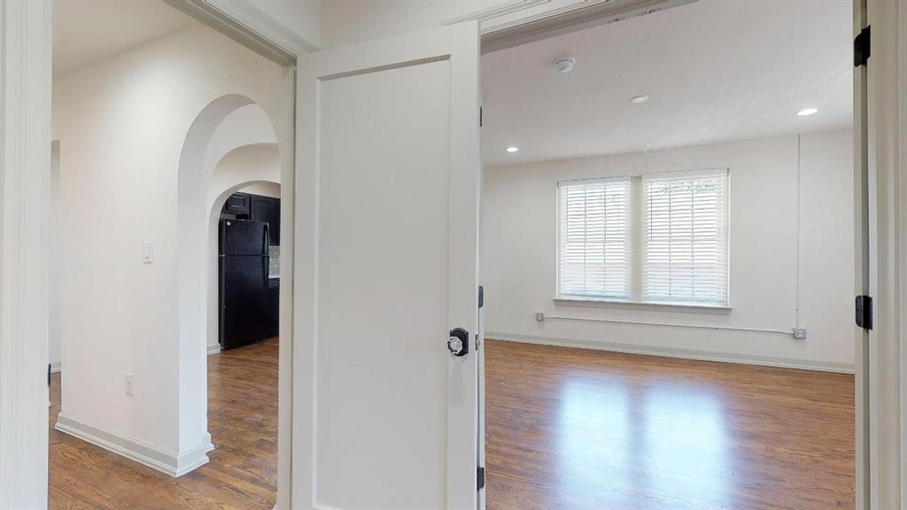 5506 Miller Avenue, Unit 202 Dallas, TX 75206 - Photo 15 of 17 an empty room with wooden floor and a window