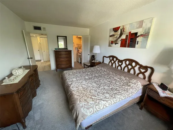 a bedroom with a bed and dresser