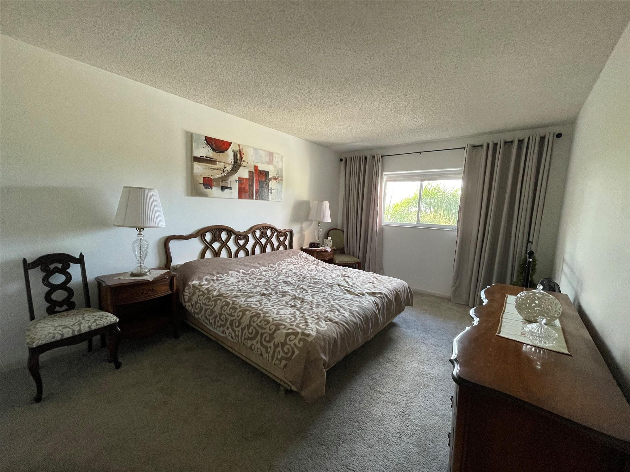 259 South Cypress Road, Unit 536 Pompano Beach, FL 33060 - Photo 12 of 39 a bedroom with a bed and a couch