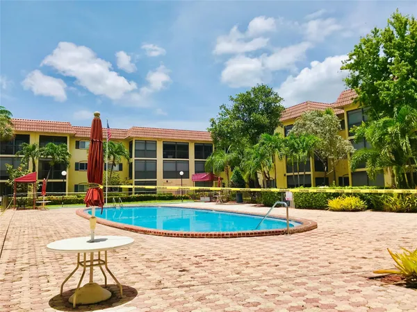 a view of a house with swimming pool and porch