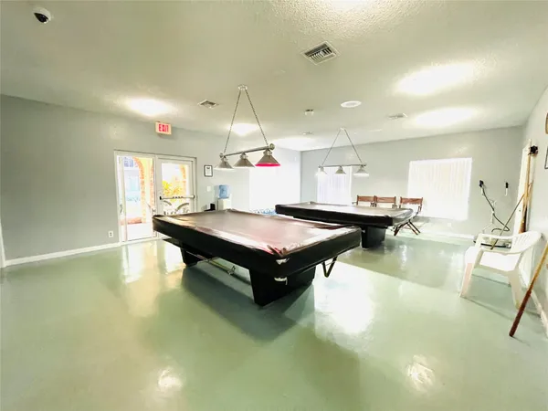a living room with table and chairs