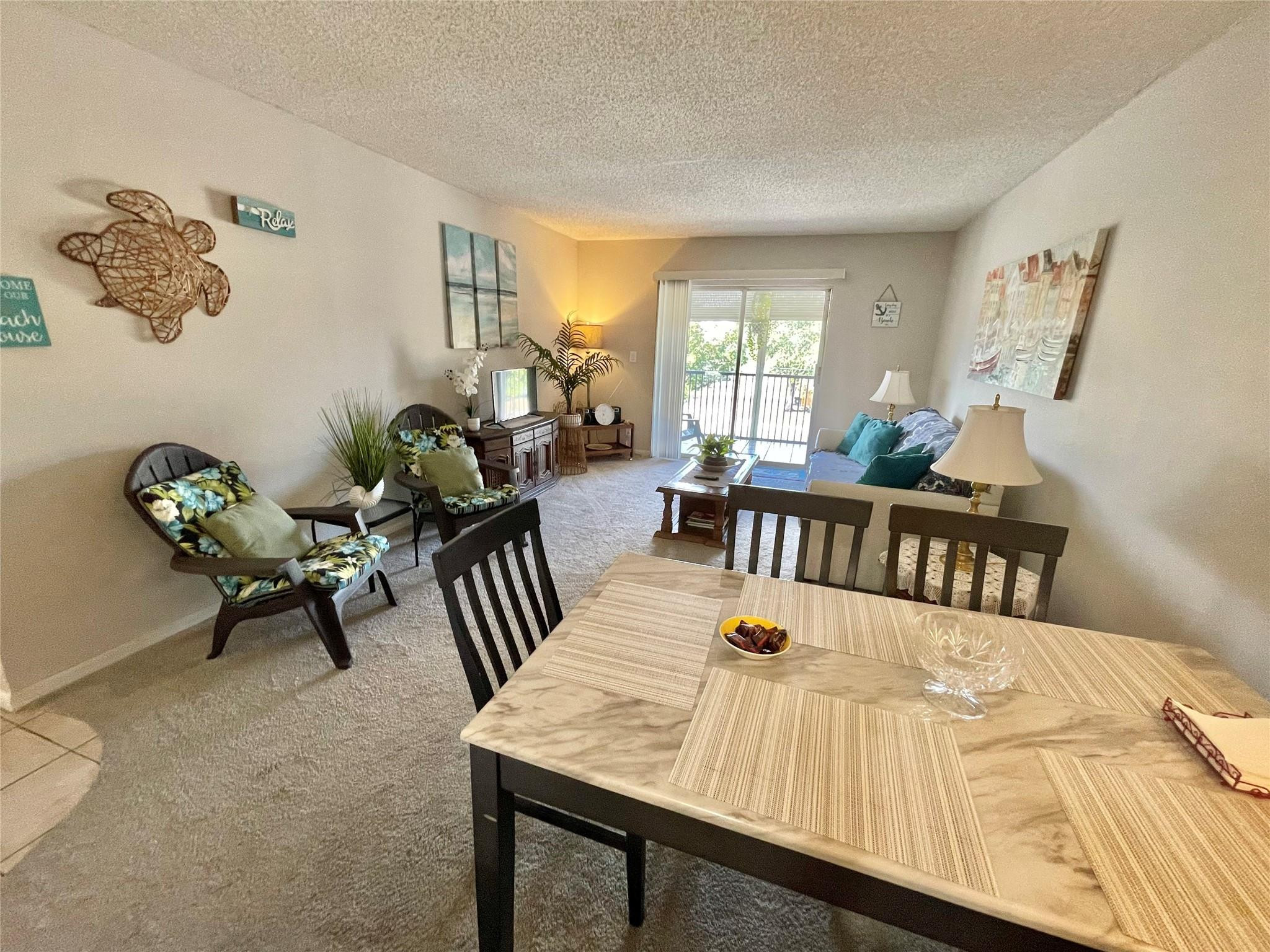259 South Cypress Road, Unit 536 Pompano Beach, FL 33060 - Photo 4 of 39 a view of a dining room with furniture and a potted plant