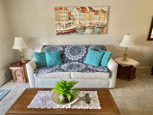 a living room with furniture rug and lamp