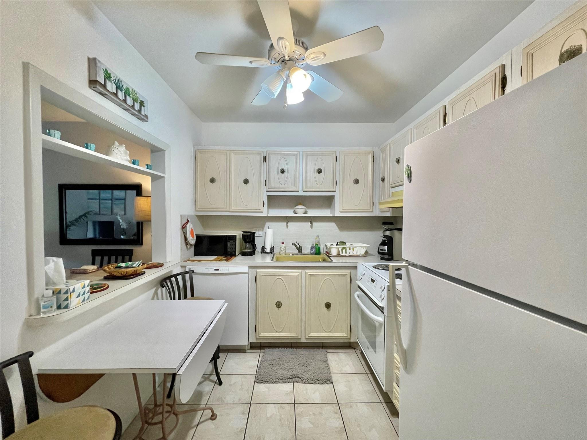 259 South Cypress Road, Unit 536 Pompano Beach, FL 33060 - Photo 9 of 39 a kitchen with cabinets a sink and a stove