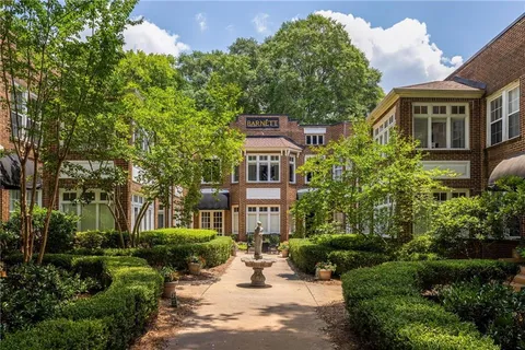 a view of a brick building next to a yard