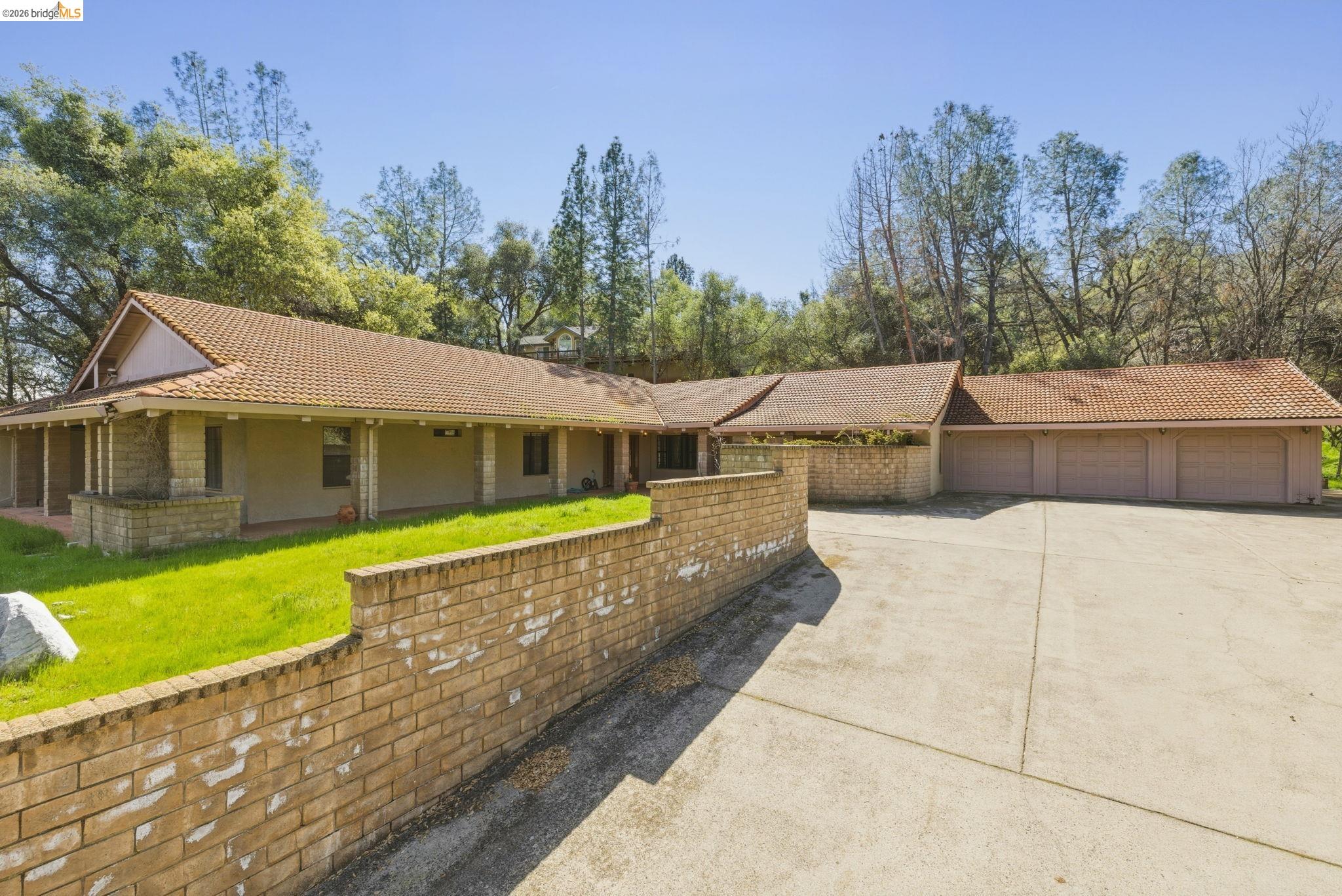 a view of a house with pool and a yard