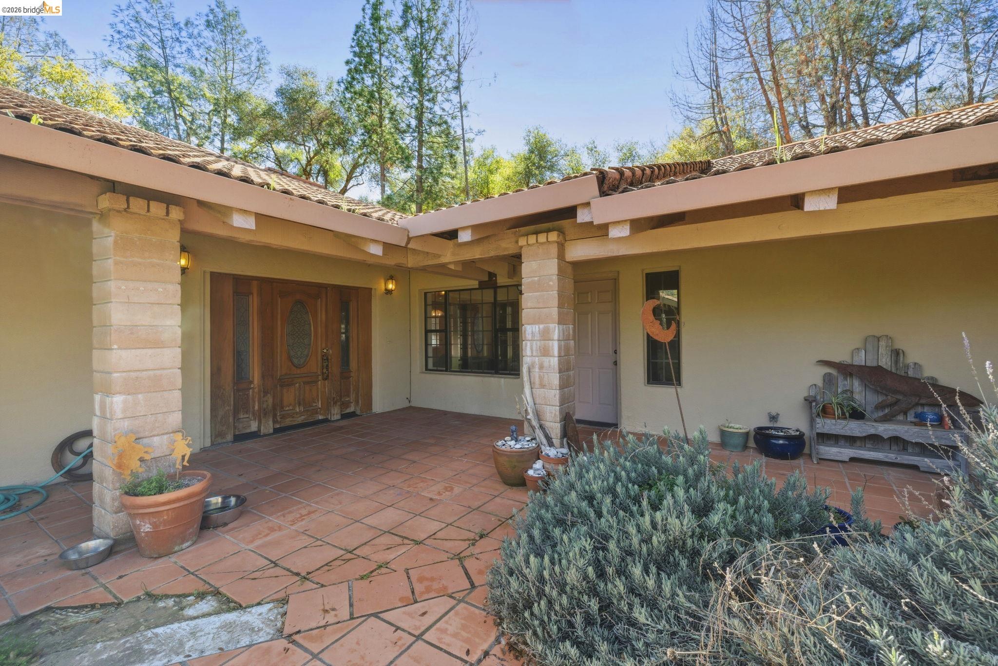 23608 Porcina Way Columbia, CA 95310 - Photo 3 of 51 a front view of a house with porch
