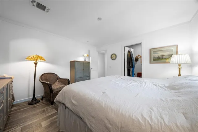 a bedroom with a bed and a lamp