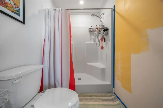 a bathroom with a shower and a shower curtain