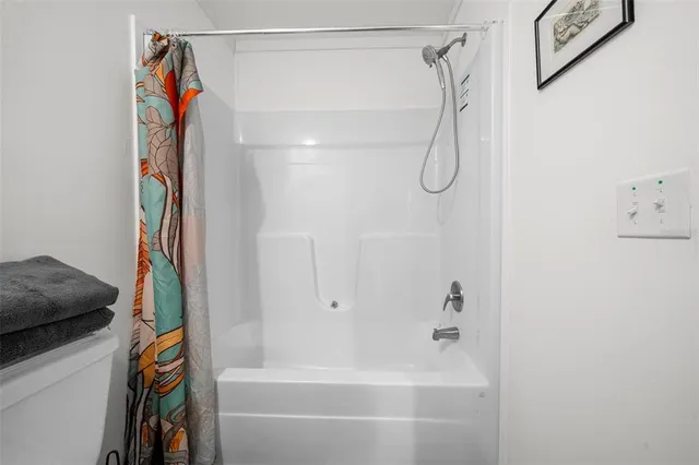 a view of a porch with wooden floor next to a yard