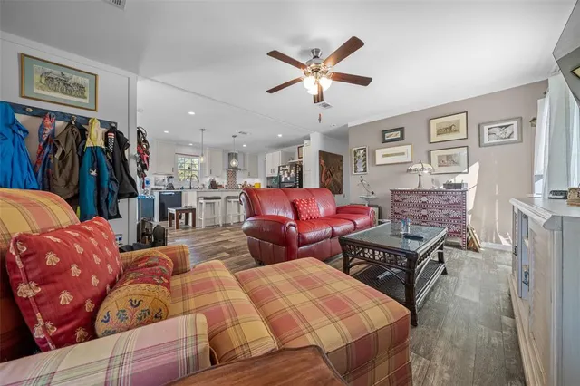 a bedroom with furniture a flat screen tv and a fireplace