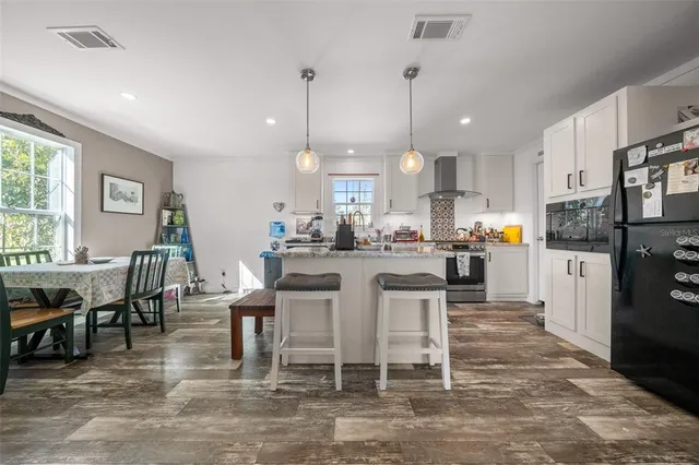 a kitchen with stainless steel appliances granite countertop a stove a refrigerator and a sink