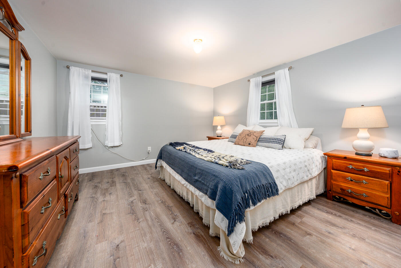 82 Skunknet Road Centerville, MA 02632 - Photo 19 of 35 a bedroom with a bed and a flat tv screen on the dresser