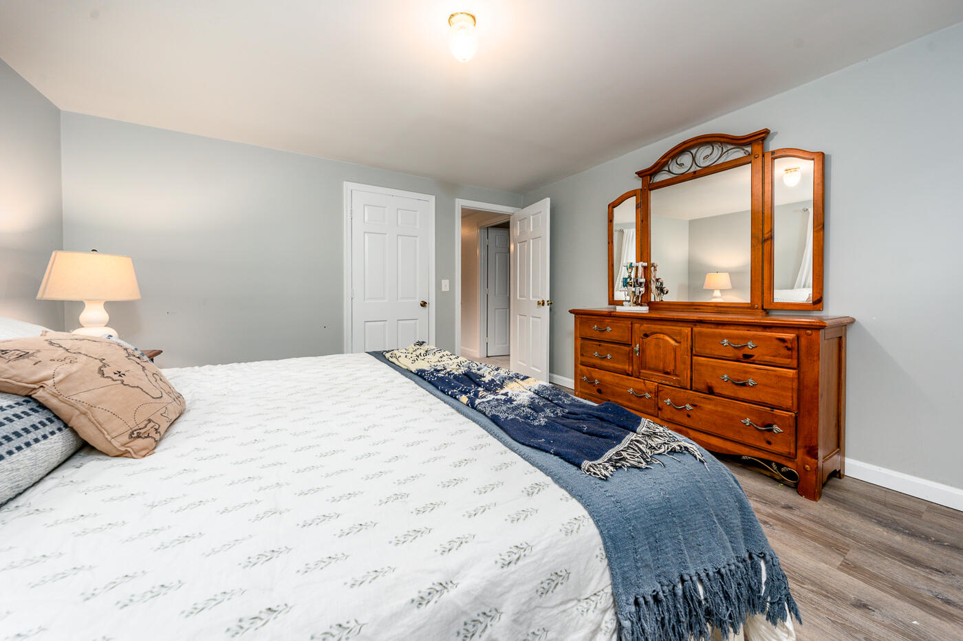 82 Skunknet Road Centerville, MA 02632 - Photo 20 of 35 a bedroom with a bed and wooden floor