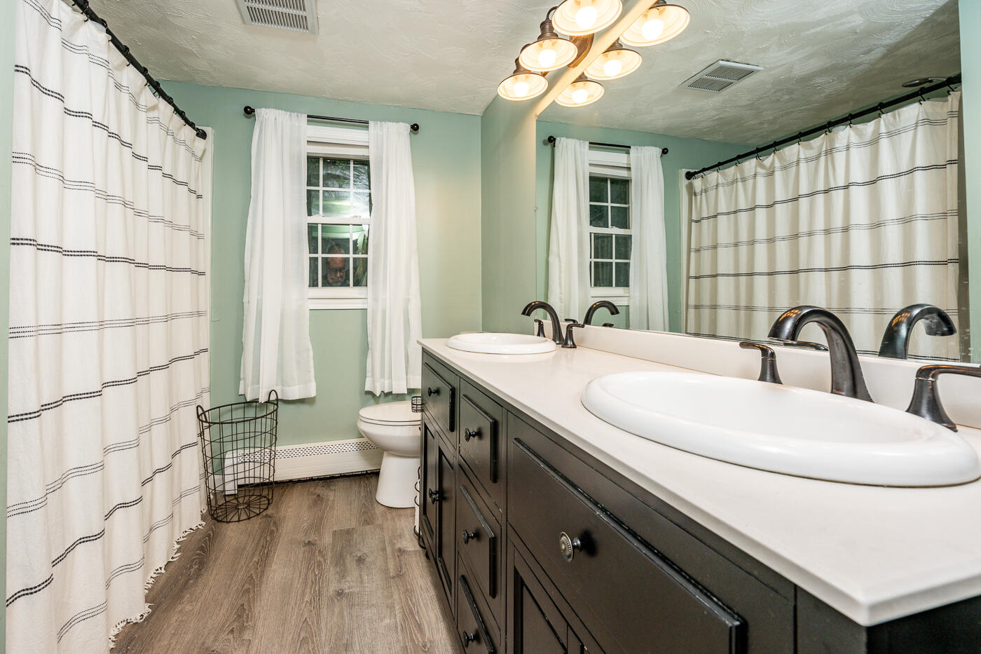82 Skunknet Road Centerville, MA 02632 - Photo 28 of 35 a bathroom with a double vanity sink mirror and toilet