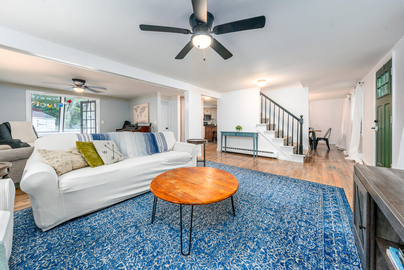 82 Skunknet Road Centerville, MA 02632 - Photo 3 of 35 a living room with furniture a table and a rug