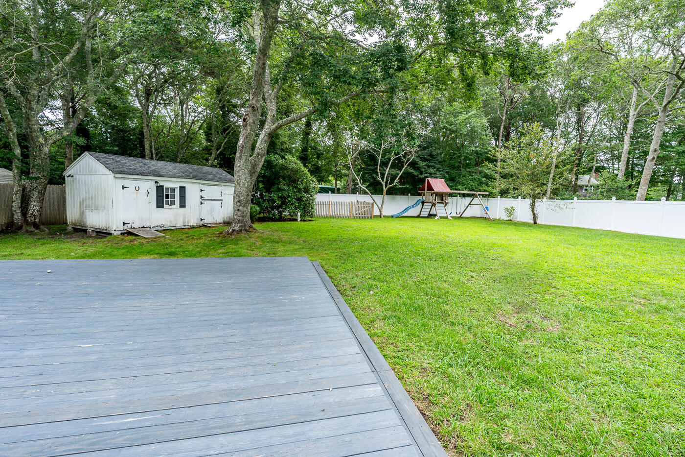 82 Skunknet Road Centerville, MA 02632 - Photo 31 of 35 a front view of a house with a yard and trees