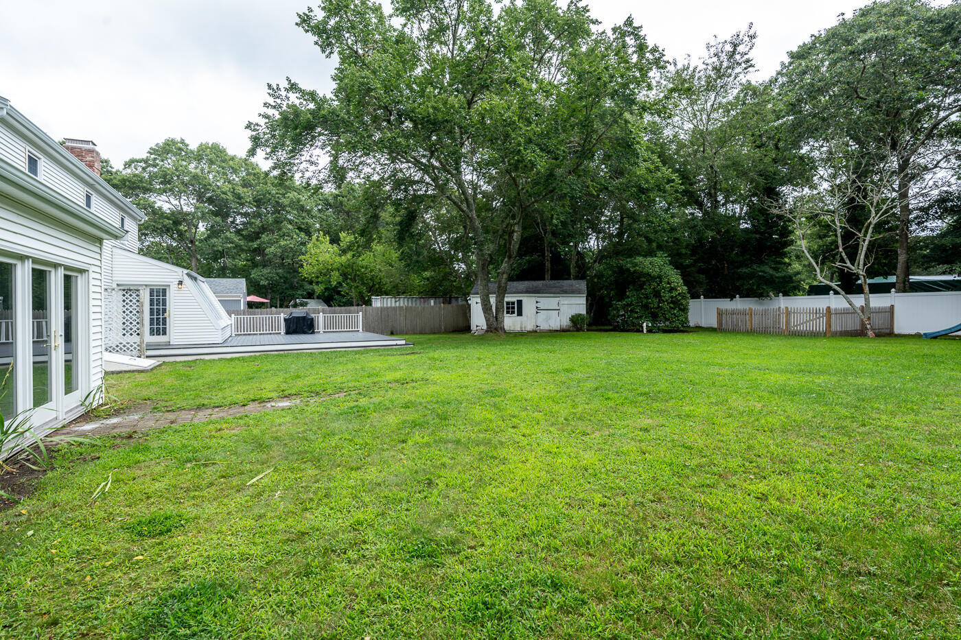 82 Skunknet Road Centerville, MA 02632 - Photo 32 of 35 a view of a house with backyard and sitting area